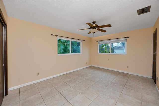 unfurnished bedroom featuring light tile patterned flooring, ceiling fan, and a textured ceiling