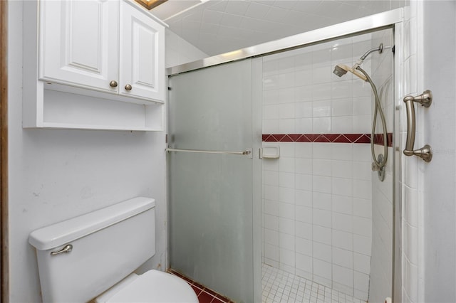 bathroom with toilet and a shower with shower door