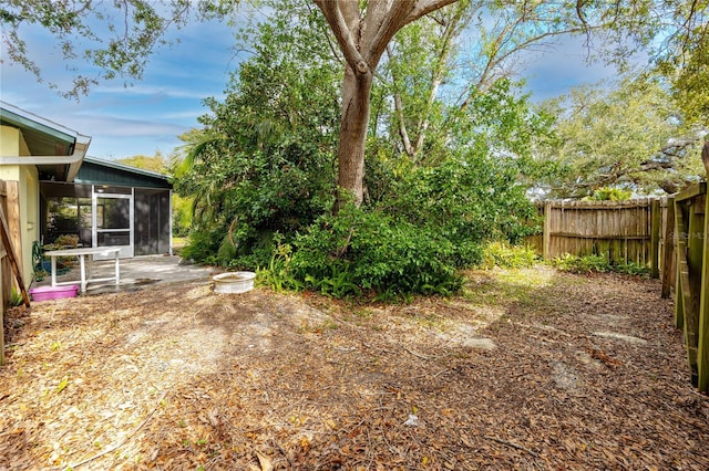 view of yard featuring a patio and a sunroom