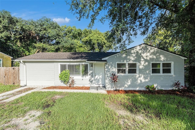 single story home featuring a front lawn