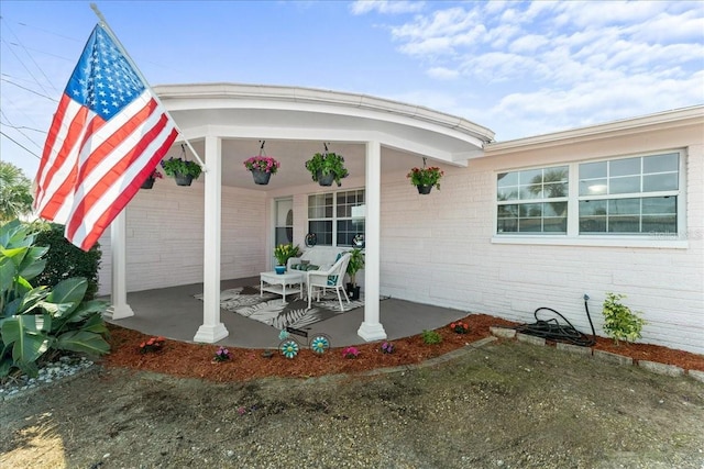 entrance to property featuring a patio