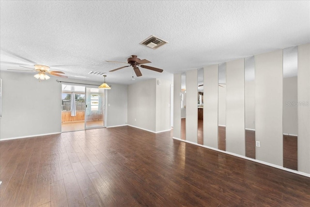 unfurnished room with ceiling fan, dark hardwood / wood-style floors, and a textured ceiling