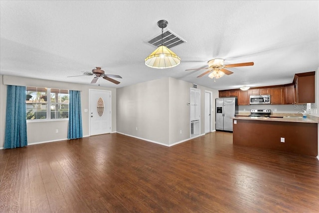 unfurnished living room with dark hardwood / wood-style floors, sink, a textured ceiling, and ceiling fan