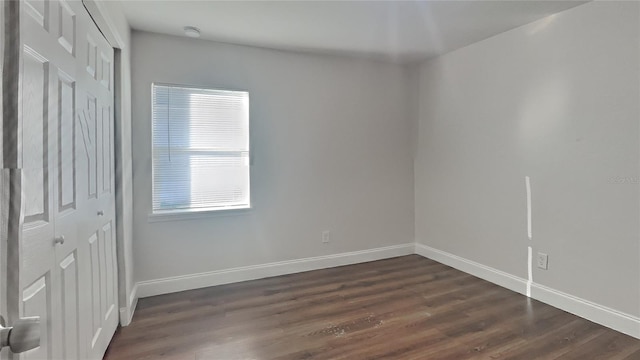 spare room with dark hardwood / wood-style flooring