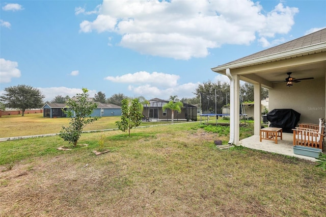 view of yard featuring a patio, a trampoline, and ceiling fan