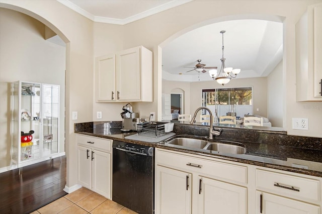 kitchen featuring pendant lighting, black dishwasher, sink, and dark stone countertops