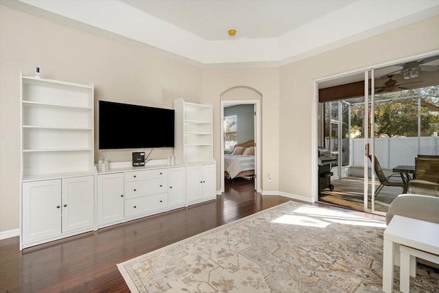 living room featuring dark hardwood / wood-style flooring and a healthy amount of sunlight