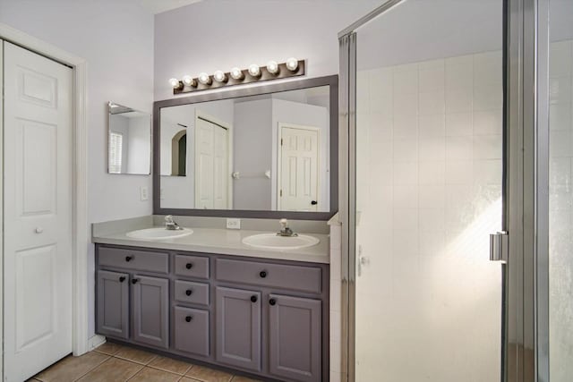 bathroom featuring vanity, tile patterned floors, and walk in shower