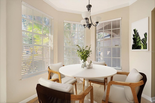 dining area featuring crown molding and a notable chandelier