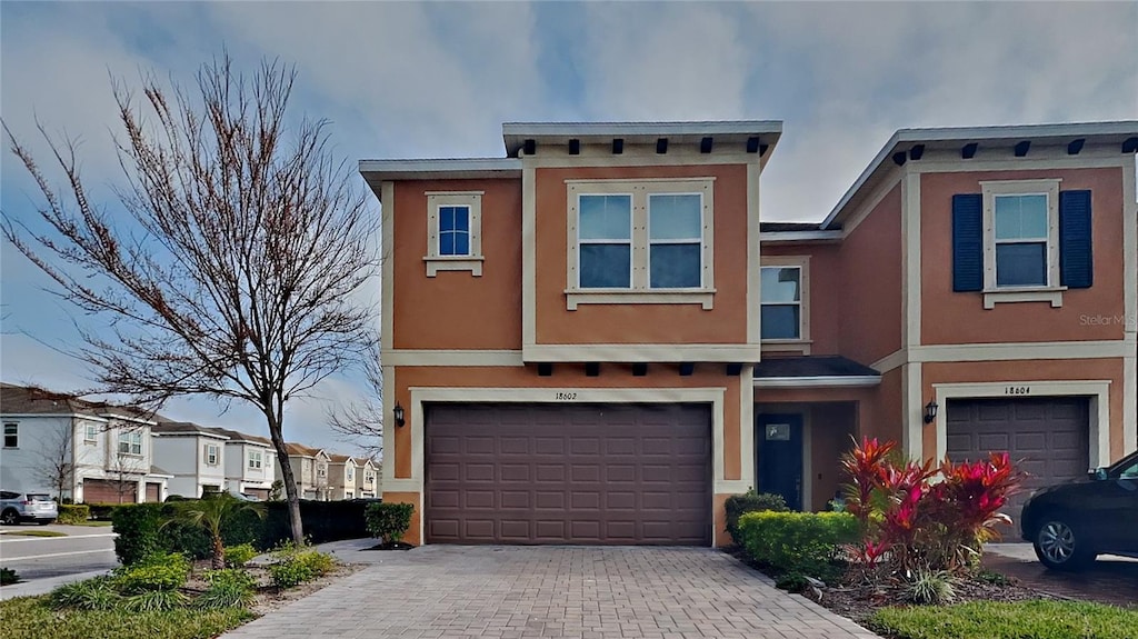 townhome / multi-family property featuring a garage