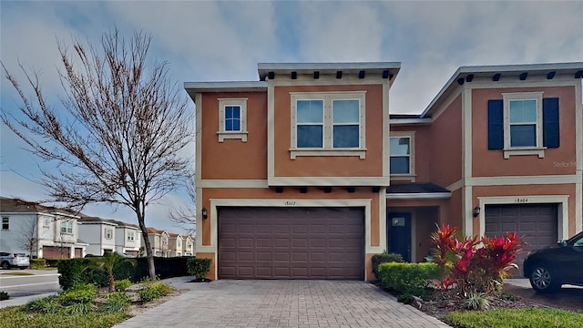 townhome / multi-family property featuring a garage