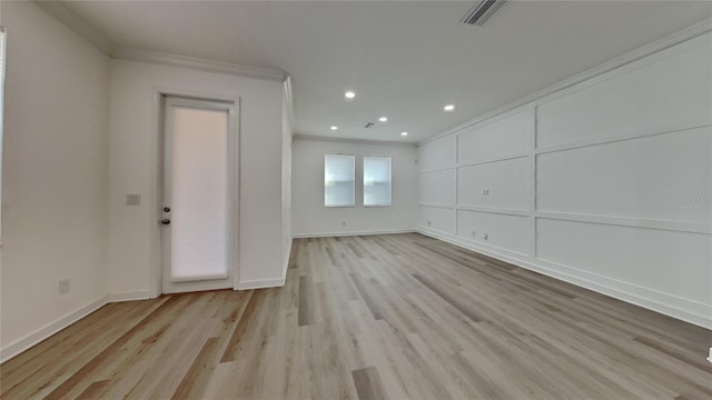 interior space with crown molding and light hardwood / wood-style flooring