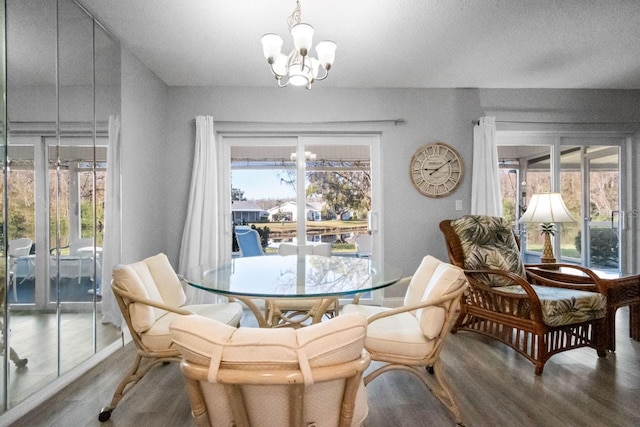 dining area featuring an inviting chandelier and wood-type flooring