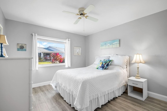 bedroom with ceiling fan and light wood-type flooring