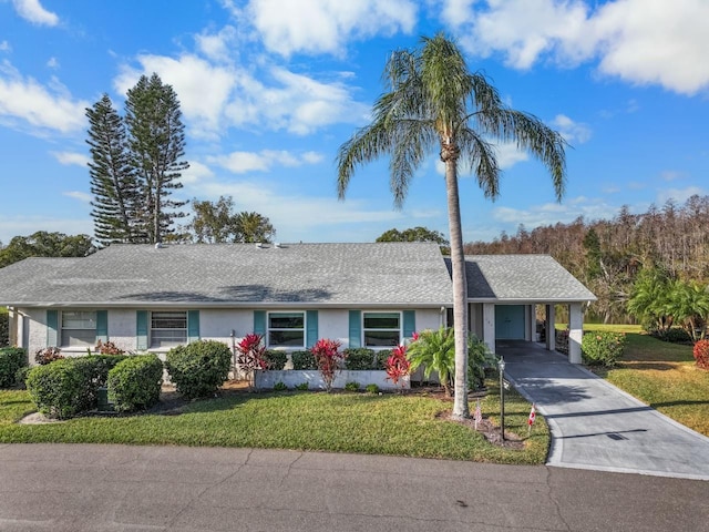 ranch-style home with a carport and a front lawn