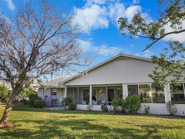 view of front facade featuring a front yard and a sunroom