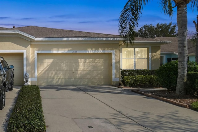 property exterior at dusk with a garage