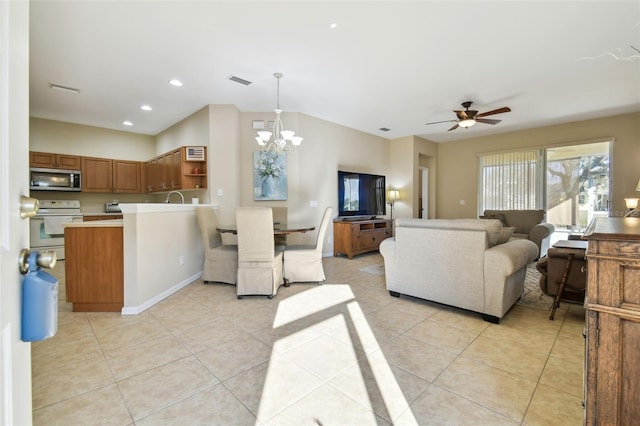 living room featuring sink, ceiling fan with notable chandelier, and light tile patterned flooring