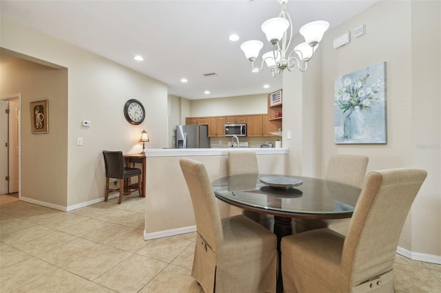 tiled dining space featuring a chandelier