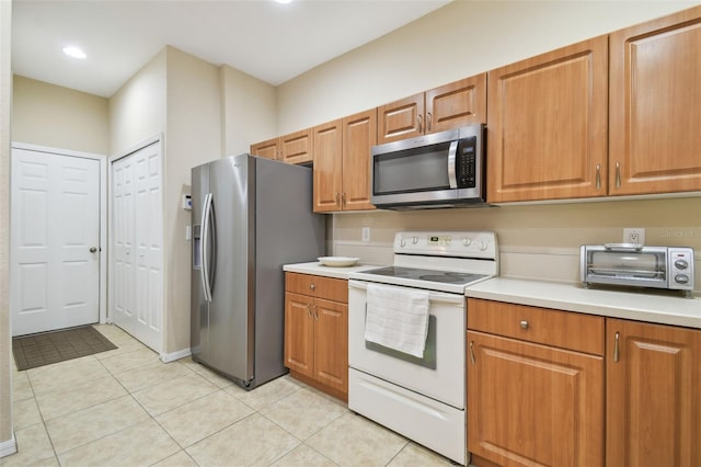 kitchen featuring appliances with stainless steel finishes and light tile patterned floors