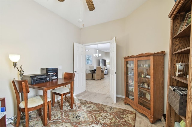 carpeted office with vaulted ceiling and ceiling fan with notable chandelier