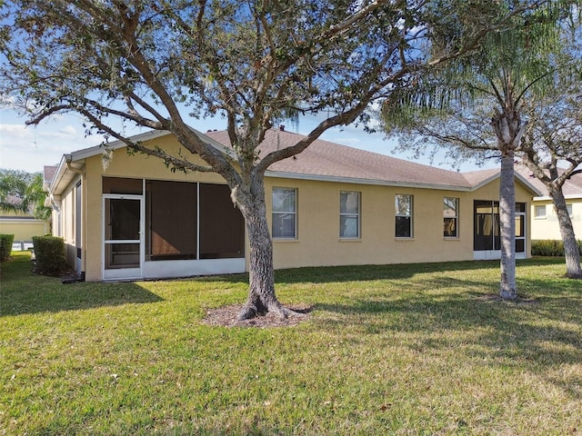 view of side of property featuring a sunroom and a yard