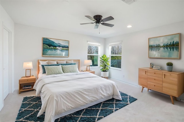 bedroom with light carpet, a ceiling fan, visible vents, and recessed lighting