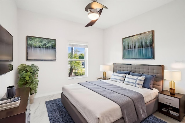 bedroom with marble finish floor, a ceiling fan, and baseboards