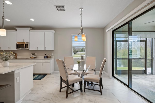 dining space with marble finish floor, baseboards, visible vents, and recessed lighting