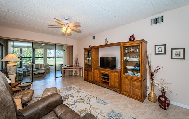 tiled living room with ceiling fan