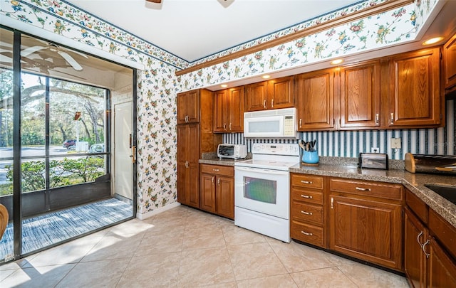 kitchen with ceiling fan, light tile patterned floors, and white appliances