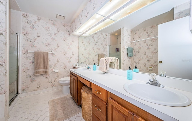 bathroom with an enclosed shower, vanity, tile patterned floors, and toilet