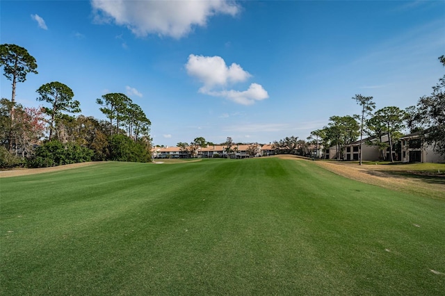 view of property's community featuring a lawn