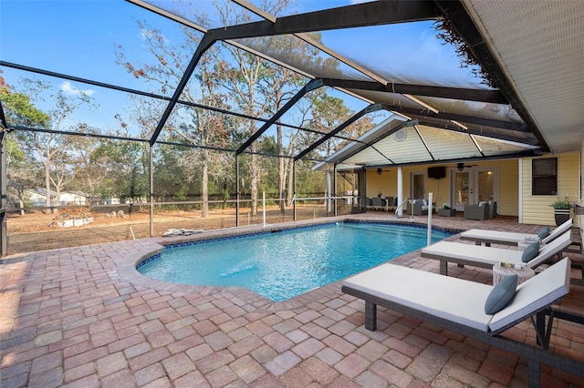 view of pool with a lanai, ceiling fan, and a patio area