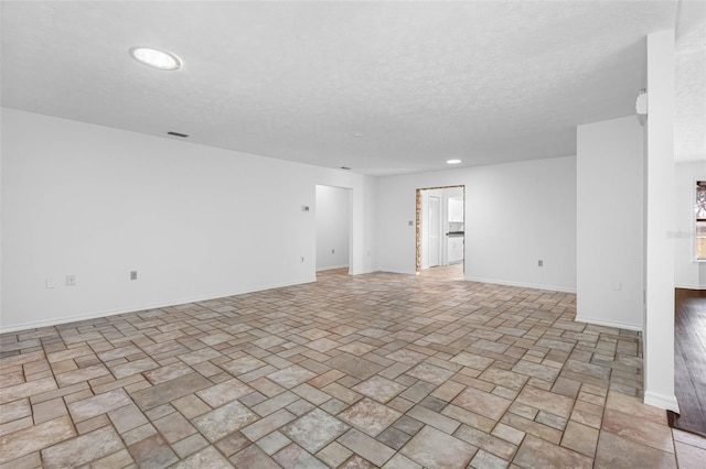 unfurnished room featuring a textured ceiling