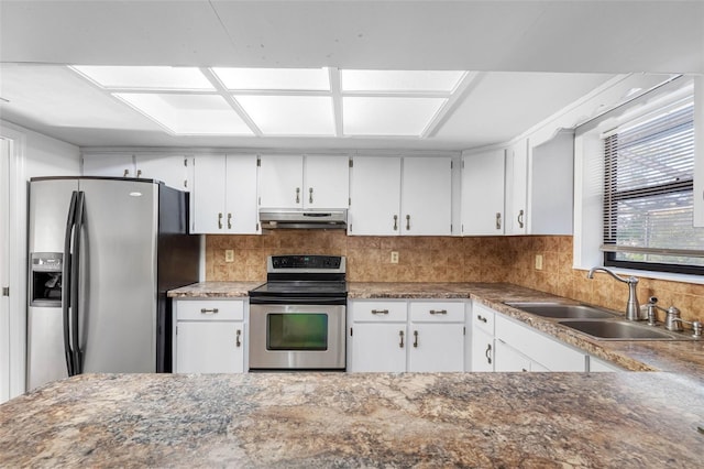 kitchen featuring tasteful backsplash, appliances with stainless steel finishes, sink, and white cabinets