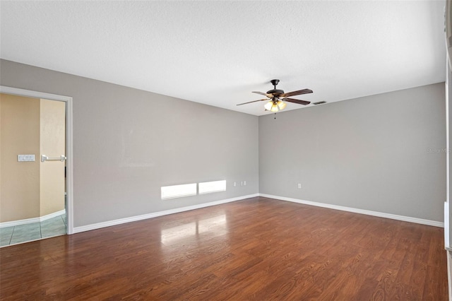 spare room featuring hardwood / wood-style floors, a textured ceiling, and ceiling fan