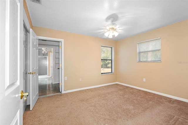 unfurnished bedroom featuring light carpet and ceiling fan