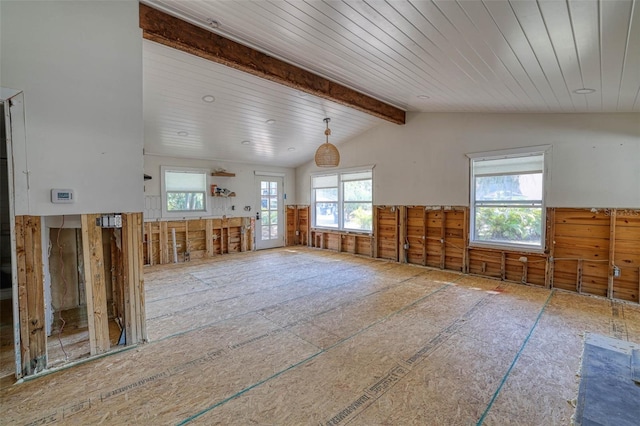 interior space featuring plenty of natural light and vaulted ceiling with beams