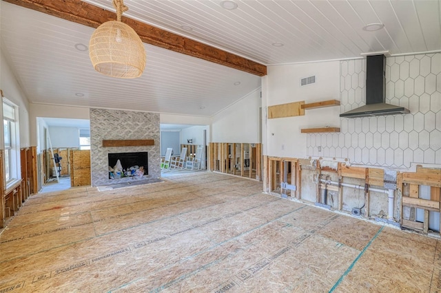 unfurnished living room with a fireplace, lofted ceiling with beams, and wooden ceiling