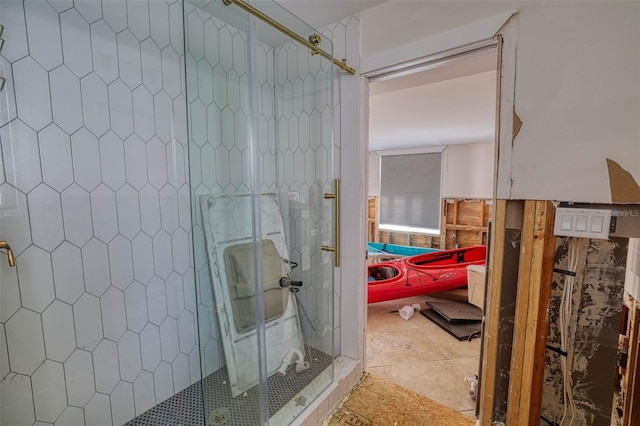 bathroom with a shower with door