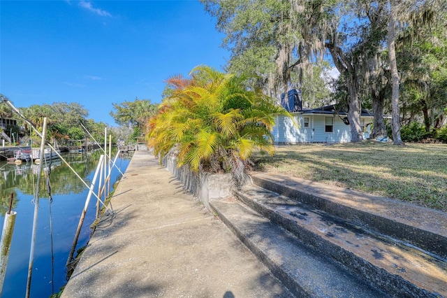 exterior space featuring a water view and a yard