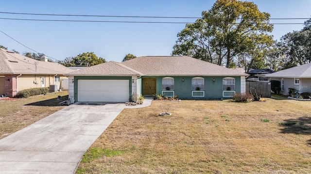 ranch-style house featuring a garage, a front lawn, and central air condition unit