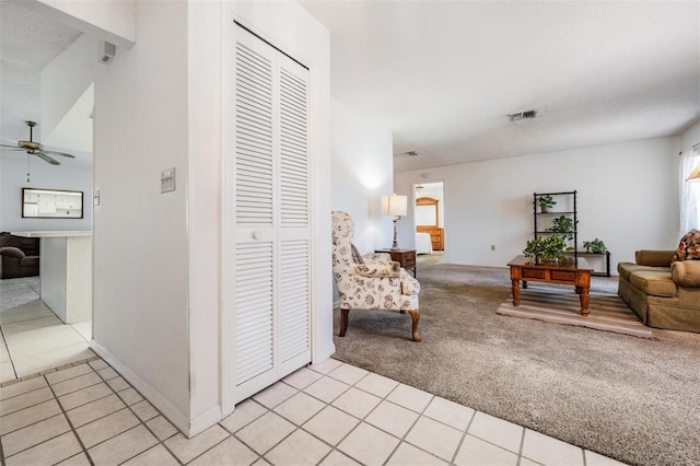 living room with light colored carpet and ceiling fan