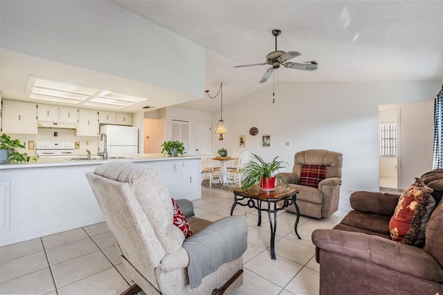 tiled living room featuring vaulted ceiling, sink, a textured ceiling, and ceiling fan