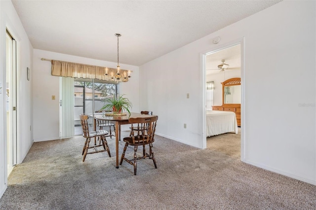 carpeted dining space featuring an inviting chandelier