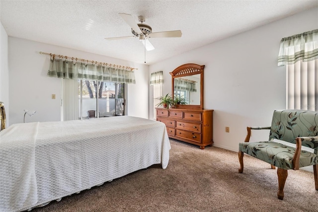 bedroom featuring ceiling fan, carpet floors, a textured ceiling, and access to outside