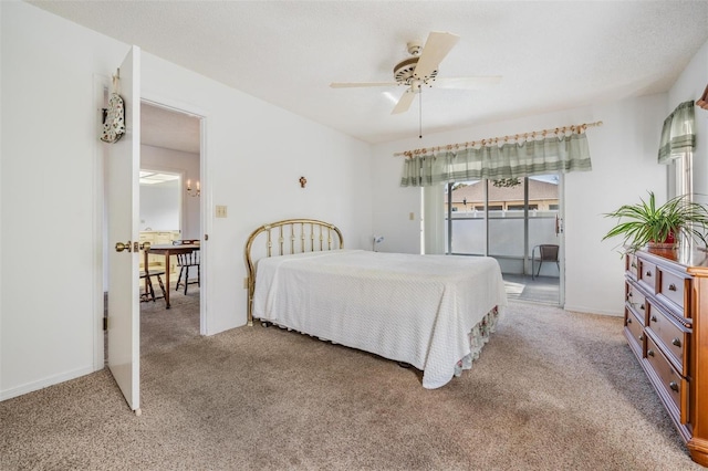 carpeted bedroom with ceiling fan, a textured ceiling, and access to outside