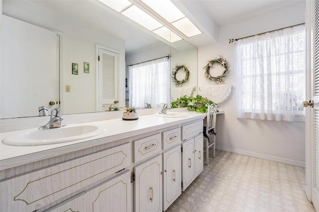 bathroom with vanity and a skylight