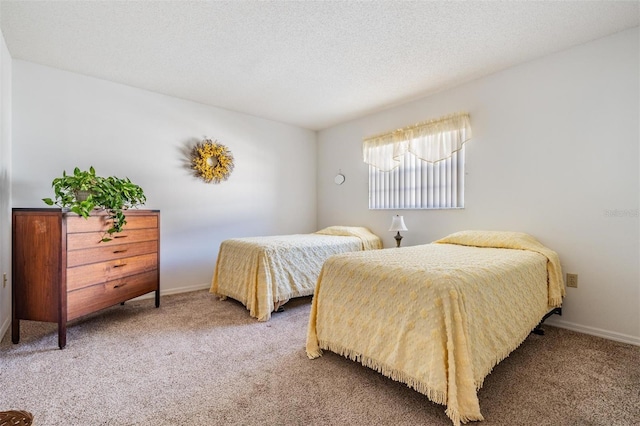 carpeted bedroom featuring a textured ceiling